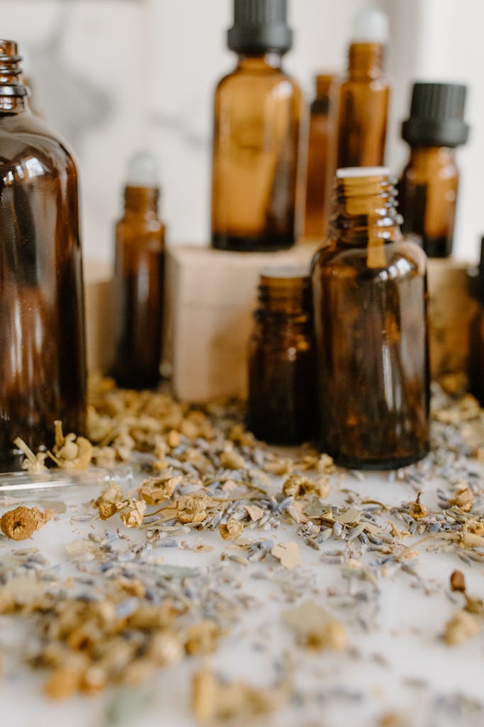 Aromatic herbal essential oils with chamomile and lavender on a white surface.